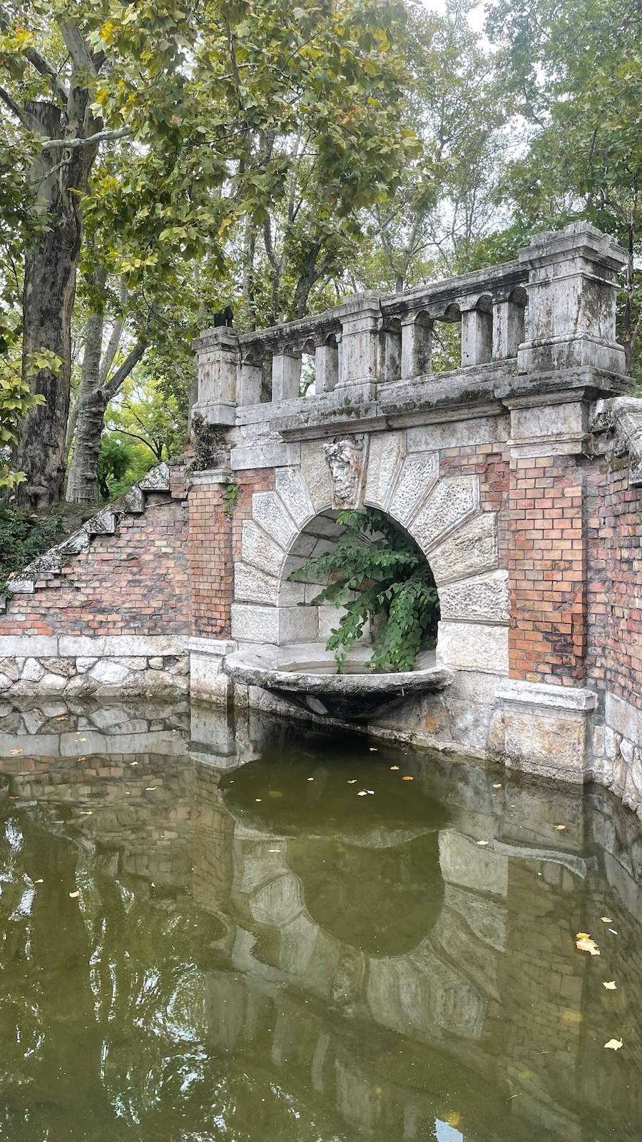 Half-hidden fountain in Budapest's City Park stroll with Pawel Zawadzki